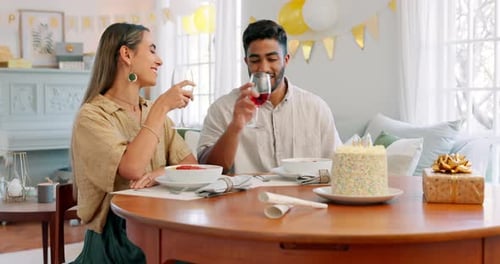 Happy, birthday and toast with couple at table for party celebration with wine, food and cake