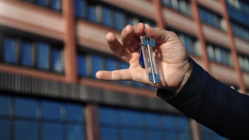 Business Man Hand Showing Keys Buying New Flat Real Estate Accommodation City House Mortgage Loan