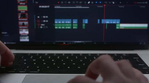 Ein menschlicher Redakteur verwendet einen Laptop, um einen Videoclip zu erstellen. Der Kameramann bearbeitet den Film