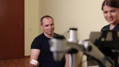 Man Receiving Electrotherapy Treatment From Healthcare Worker