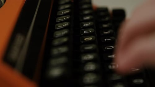 Writing letters with orange retro vintage typewriter