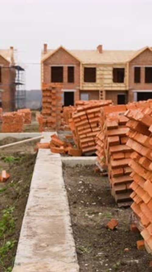 Stacks of Red Bricks at Duplex Cottage Construction Site
