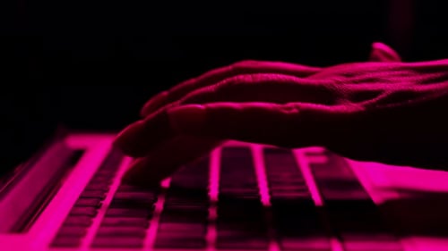 Close Up of Hands Typing on a Laptop Keyboard