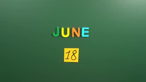 Hand sticking a sticker 18 June calendar day on school board. 18 date of June. Eighteenth day