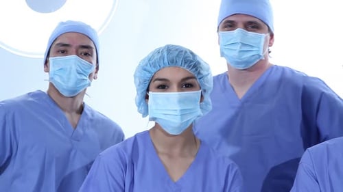 Surgeons wearing masks and scrubs