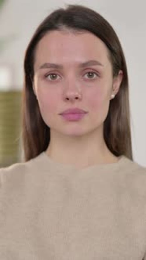Portrait of Young Woman Looking at Camera at Home, Vertical Video
