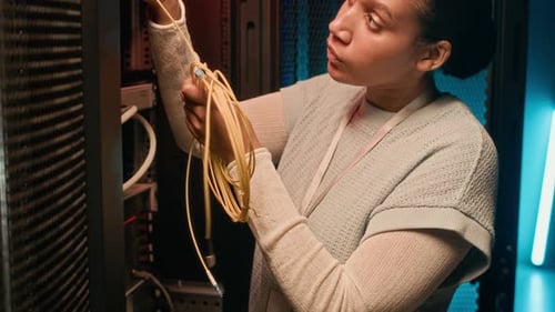 Data Center Worker Checking Cable System in Supercomputing Equipment