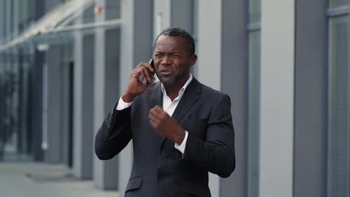 Man Talking on Phone Outside Office Building