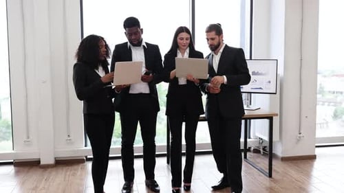 Diverse Business Team with Laptops in Modern Office