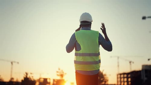 Construction and Development Architect or Engineer Talking By Phone Back View Professional and
