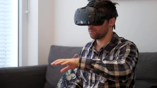 Man Wearing VR Headset Interacting with Virtual World