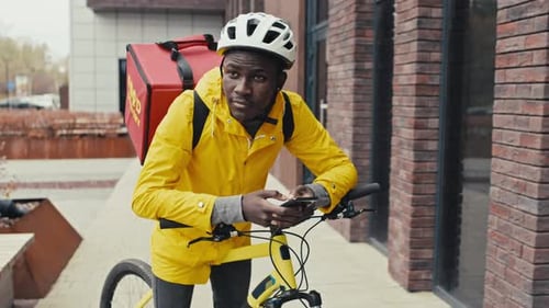 Delivery Cyclist Using Mobile Phone in Urban Setting