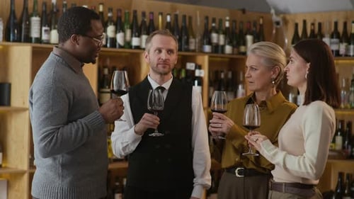 Diverse People and Sommelier Engaged in Conversation during Wine Tasting