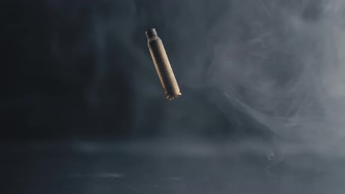 Rotating Empty Bullet Shell Casing on Smoky Background