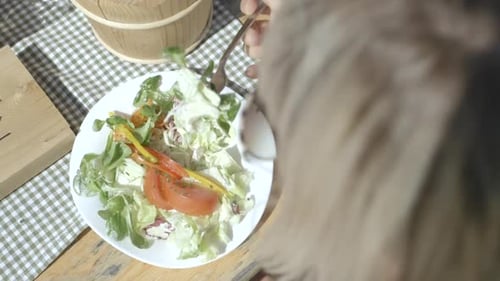 Woman eating a meal outdoors