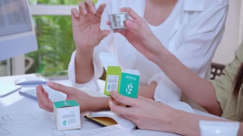Hand holding cosmetic packaging mockup box, graphic designer and development branding project.