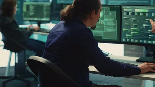 Man Working on Computers in Technology Office