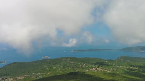 Flying through white clouds over sea
