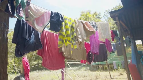 Colourful clothes on garden washing line sway gently in the drying breeze