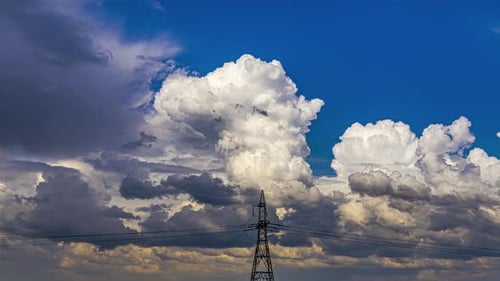 Timelapse of Cloudy Sunrise with Tall Electricity Pylons Under Blue Sky