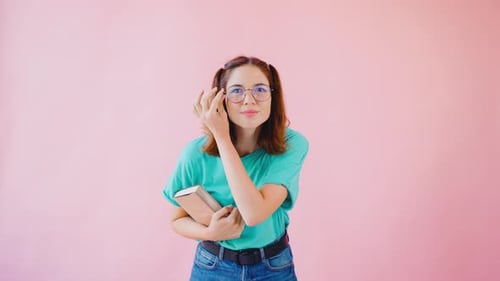 Smiling Woman Holding Book Poses in Studio