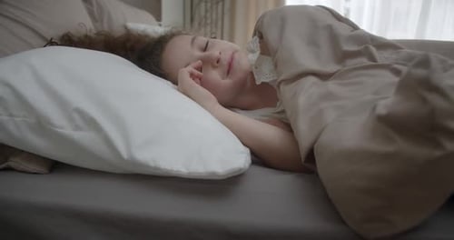 Young Child Sleeping Peacefully in Bed at Home