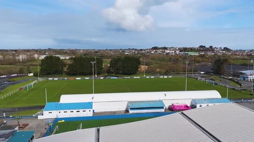 Low flight over grandstand at sports stadium on bright sunny day