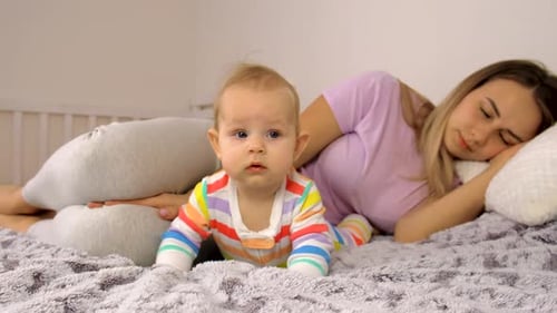 Sweet Baby Near Sleeping Woman on Bed