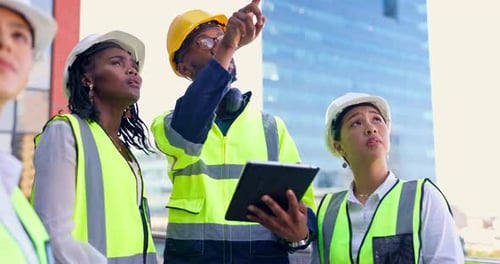 Construction Team Plans at Urban Building Site