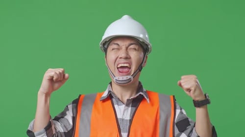 Asian Male Engineer With Safety Helmet Screaming Goal Celebrating Working In The Green Screen