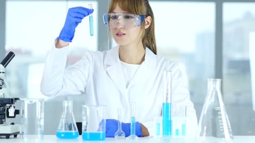 Woman Scientist Examining Test Tube in Laboratory