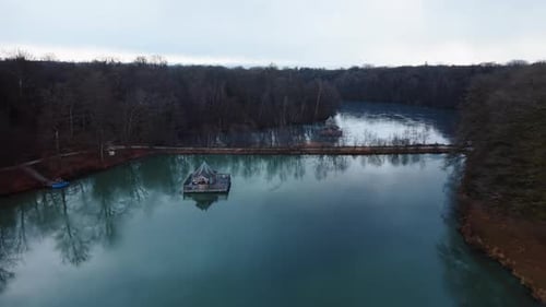 Aerial: two wooden houses on Verchat pond and Cabanes des Grands Reflets during the day in Joncherey