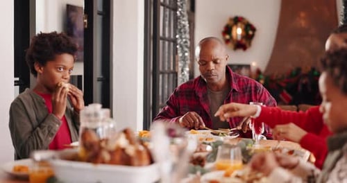 Christmas dinner, family and pass plate in home with children, talk and parents bonding