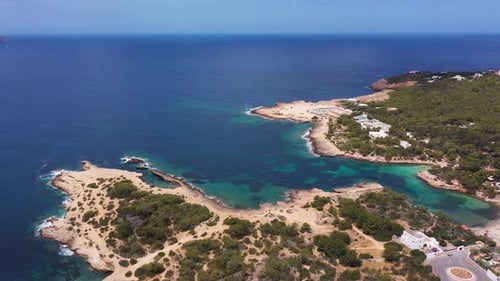 Aerial drone footage of a beach known ad Cala Gració in the village of Sant Antoni in Ibiza Spain