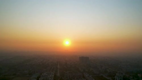 Sunset timelapse over a smog-covered cityscape in winters