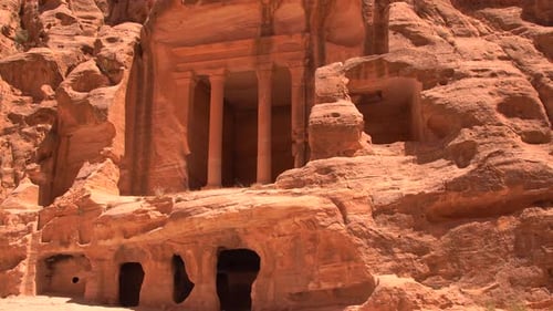 Ancient Rockcut Facade with Columns Carved Into the Sandstone Cliffs of the Desert Landscape at