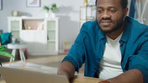 Man working at a laptop in a living room