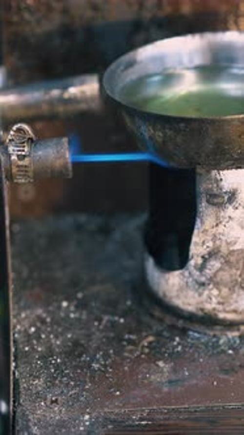 Jeweler Installs Gas Burner to Heat Liquid in Shop Closeup