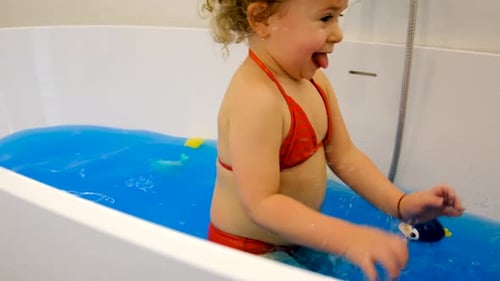 The Child Bathes in the Bath Paint Blue Color