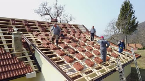 Contractor repairing roof top of the house