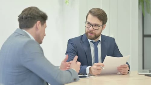 Talking Businessmen During Meeting Shaking Hand in Office