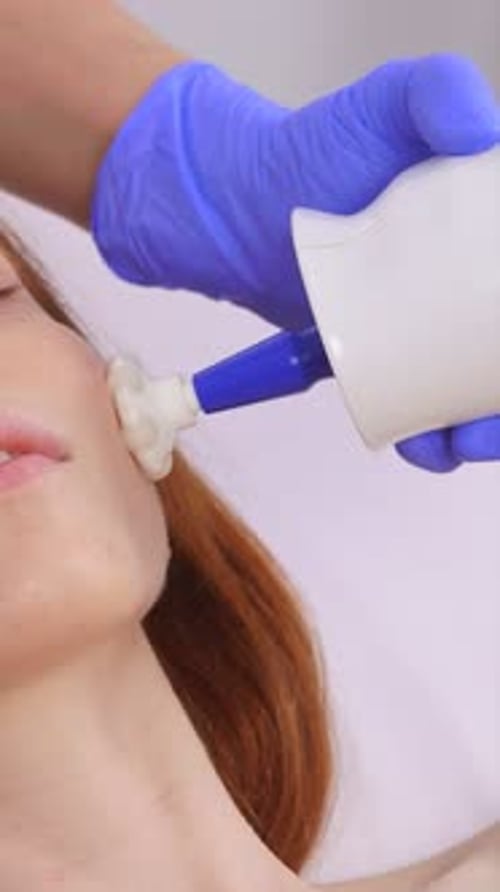 Woman receiving facial treatment at a medical clinic