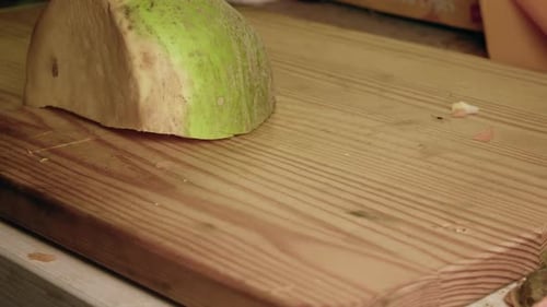Close-up Raw Turnip is cut into pieces on wood chopping block