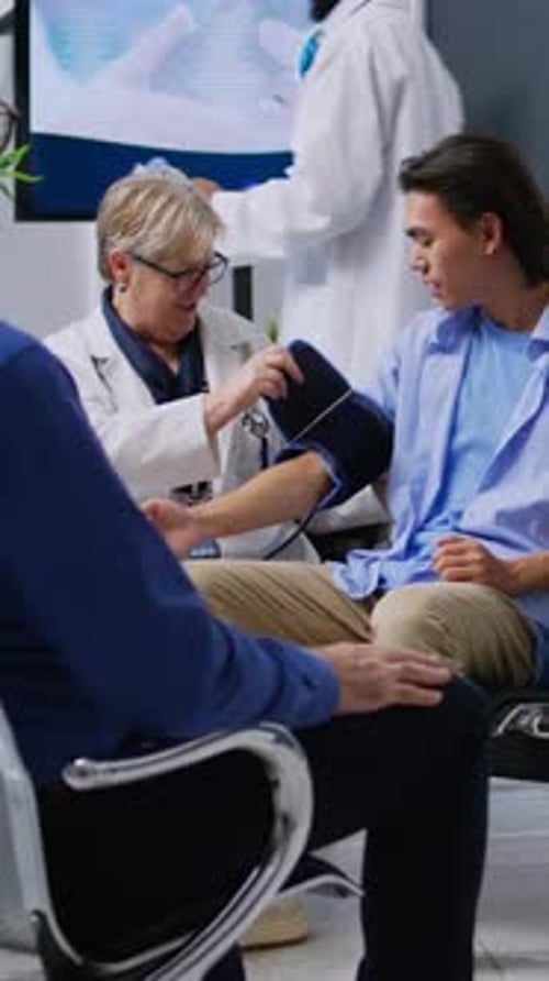 Doctor Checks Young Patient's Blood Pressure
