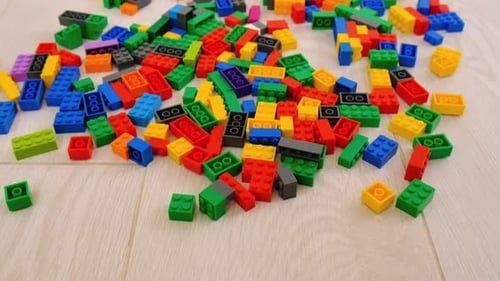 Scattered Plastic Building Blocks on a Light Surface