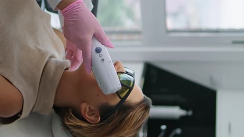 Woman Lying Rejuvenation Laser Procedure at Cosmetology Clinic Vertical Close Up