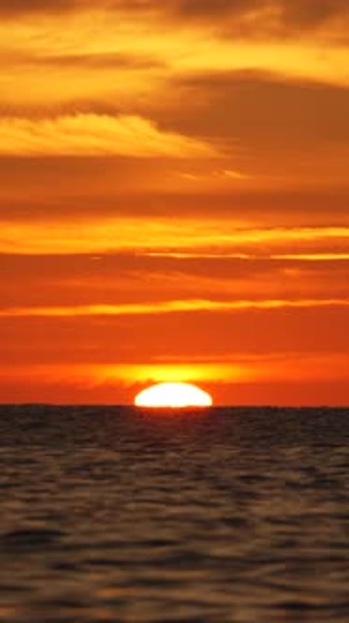 Sunset Ocean Sky Fiery Orange Twilight Over Calm Sea Horizon at Dusk Serene Natural Beauty Vertical