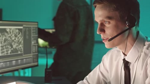 Man Working at Computer with Map and Radar Screens