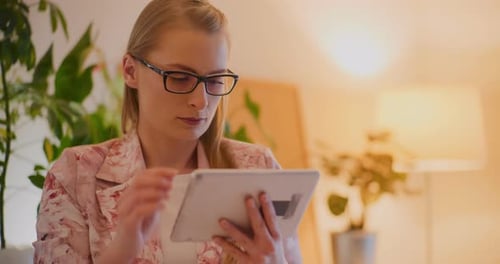 Woman Using Tablet Computer in Home Setting
