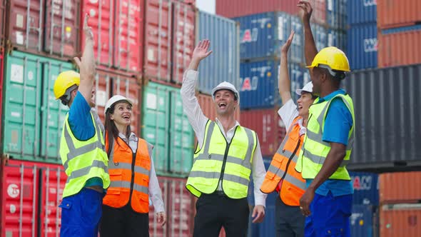Group of man and woman worker clap hands while work in container port ...